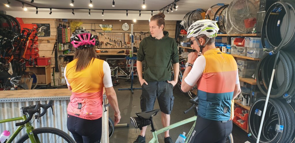 Two cyclists in Bike Man Dan's workshop