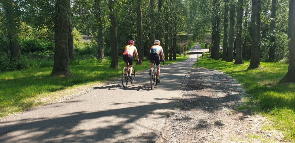 two cyclists cycling up the track at Umberslade farm