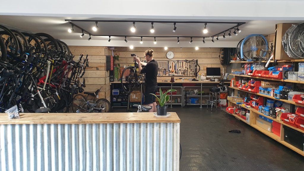 Bikes hanging on the wall in Bike Man Dan's Workshop, Umberslade Estate